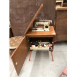 A Jones domestic sewing machine, model 434 in teak finish cabinet,