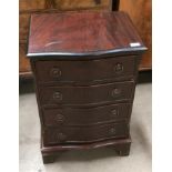 A reproduction mahogany serpentine front miniature chest of four drawers,