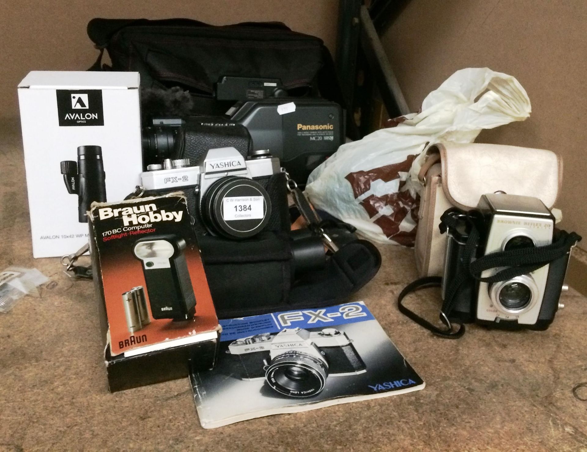 Panasonic MC20 VHS-C movie camera and carry bag, Yashica FX-2 camera, small pair of binoculars,