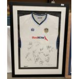 Leeds United Interest: A framed and mounted Admiral Red Kite Leeds United shirt with signatures,