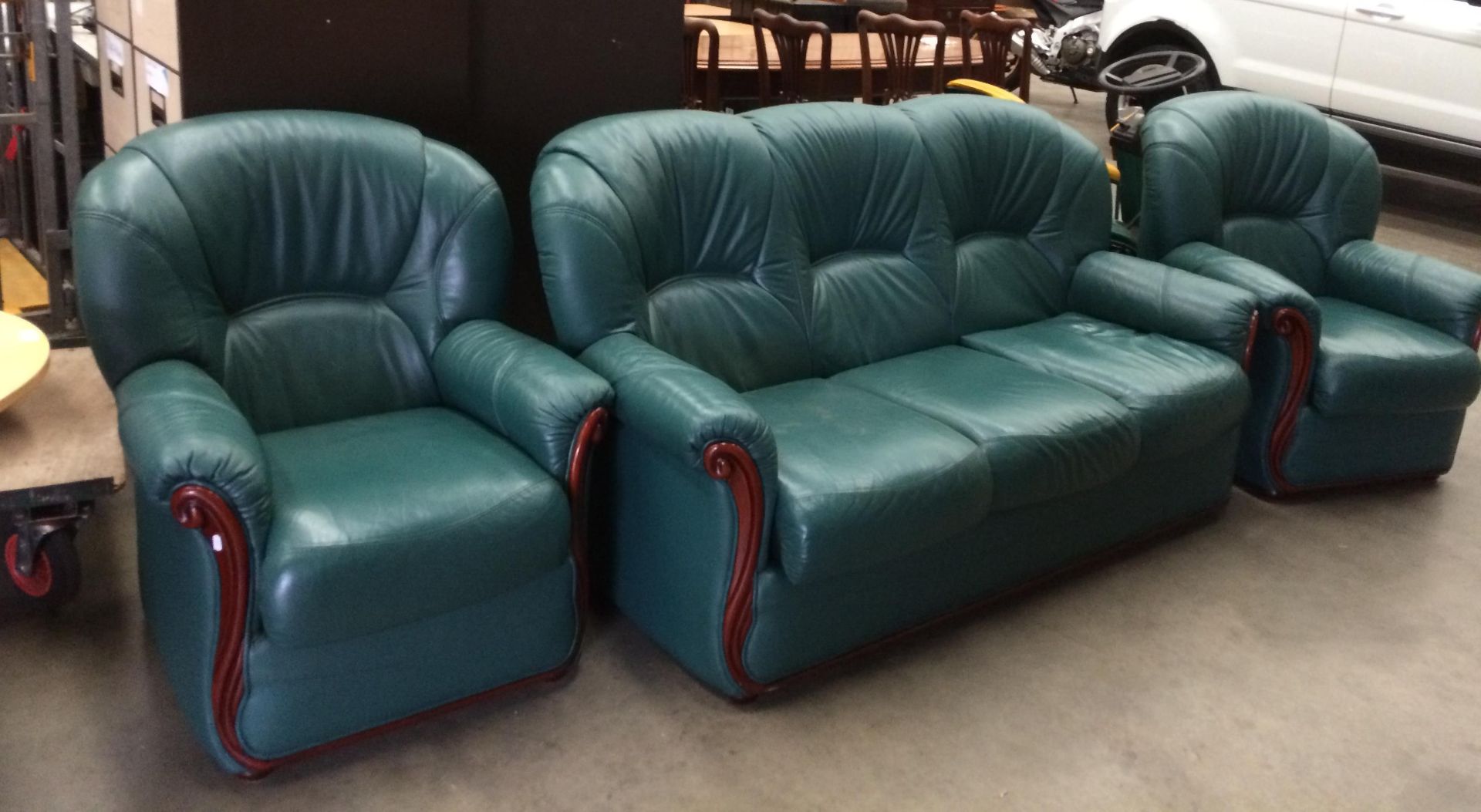 A MF International Italian green leather three piece suite with wood trim (with fire labels)