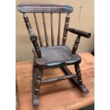 An oak finish child's rocking chair