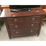 A mahogany finish four drawer (two short and two long) chest of drawers,