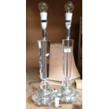 A pair of clear perspex table lamps, each 60cm high,