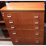 A teak finish five drawer chest of drawers