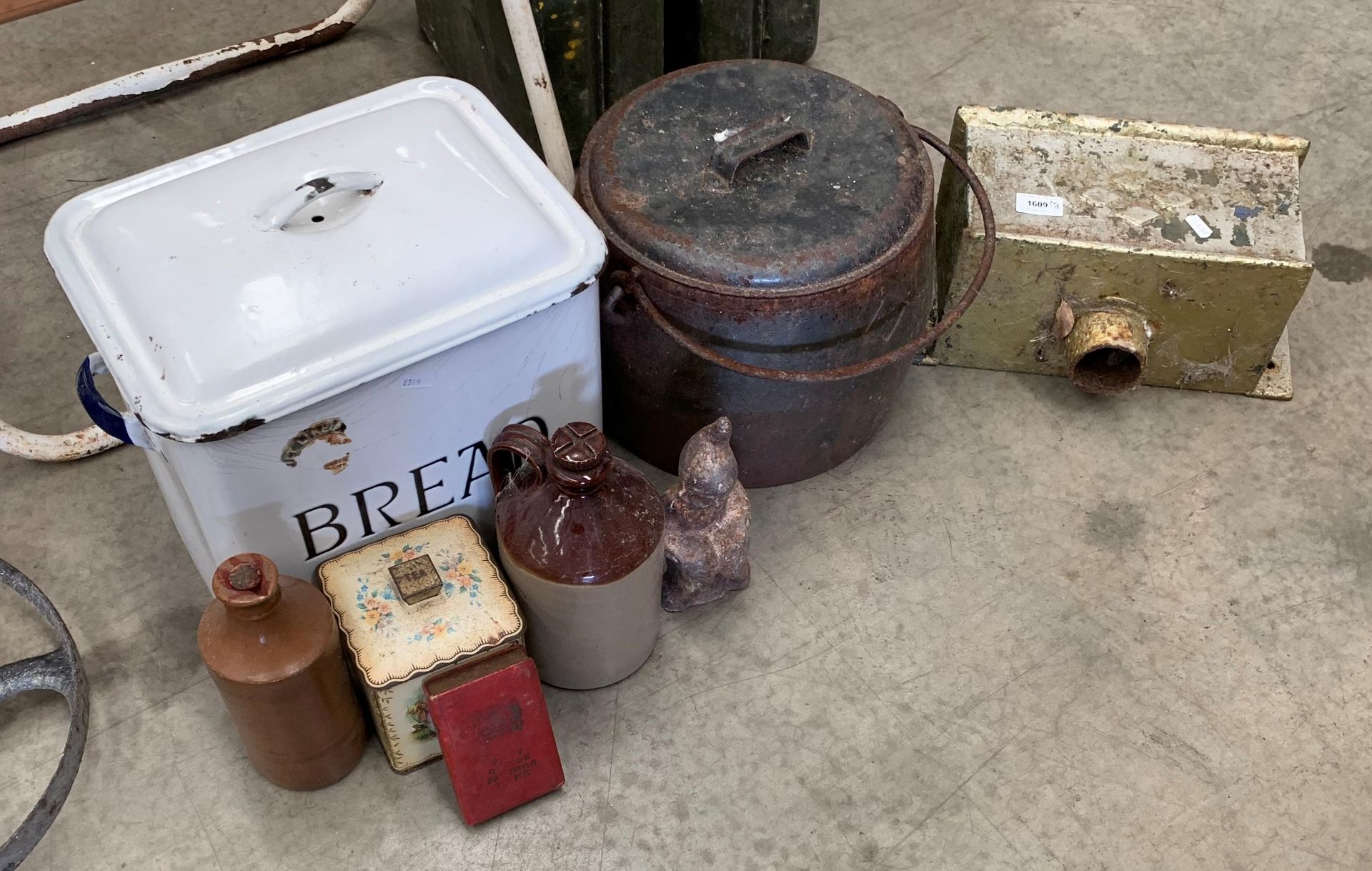 A white enamel bread bin, a cast metal cooking pot with lid, small garden gnome, etc.