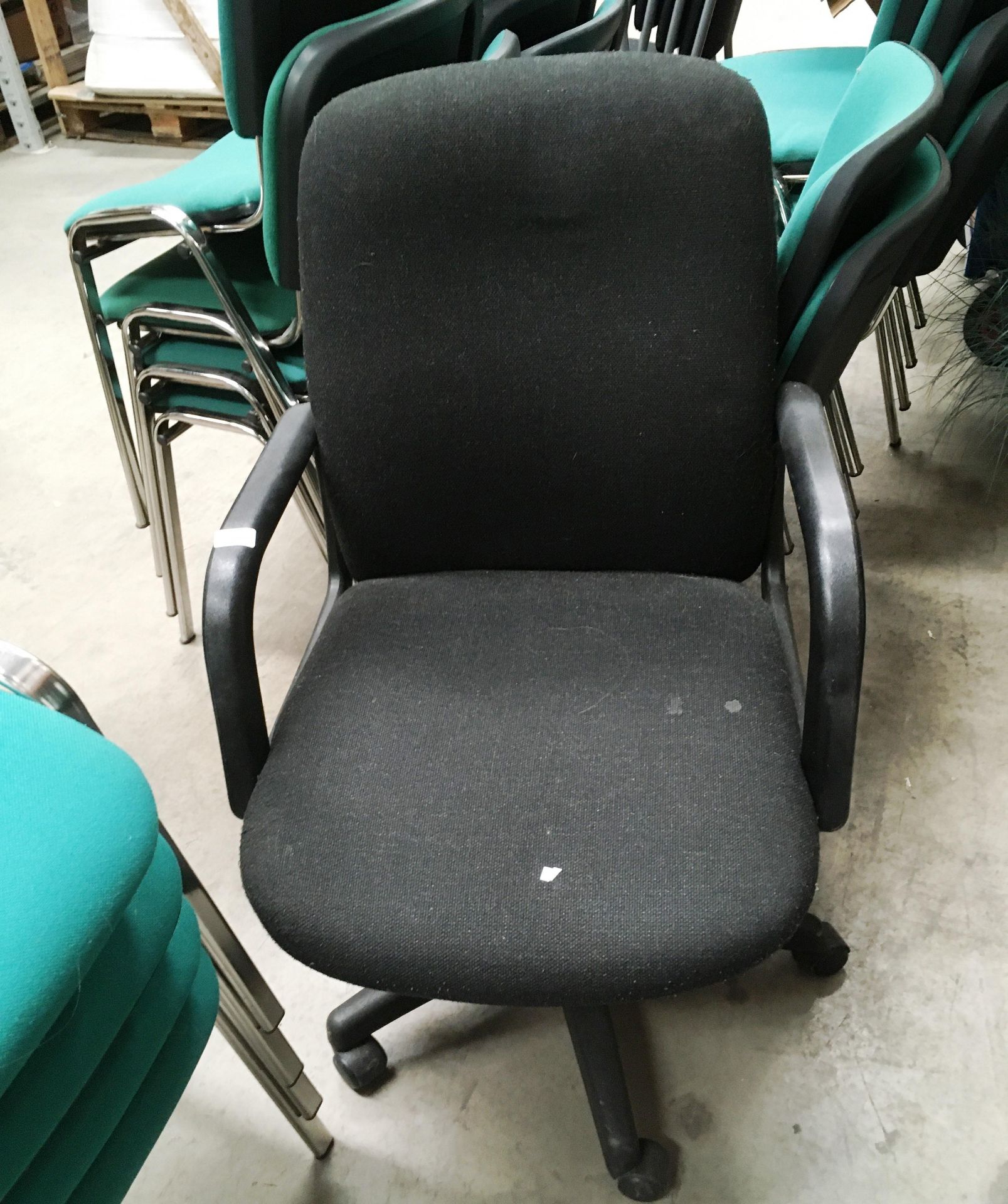 A charcoal grey upholstered office swivel armchair