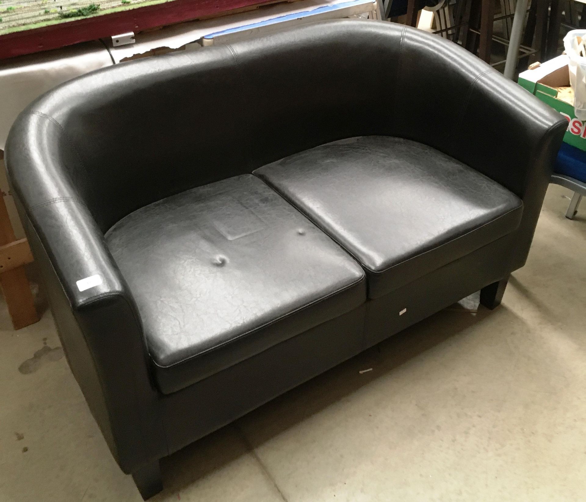 Black vinyl two seater reception settee on dark wooden legs