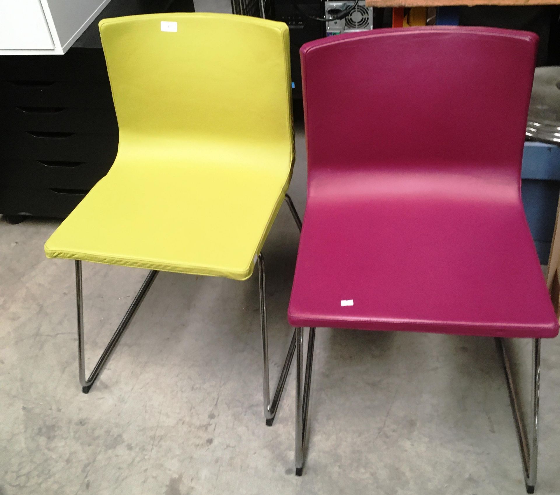 Two vinyl upholstered office chairs on chrome bases - 1 x purple and 1 x lime green