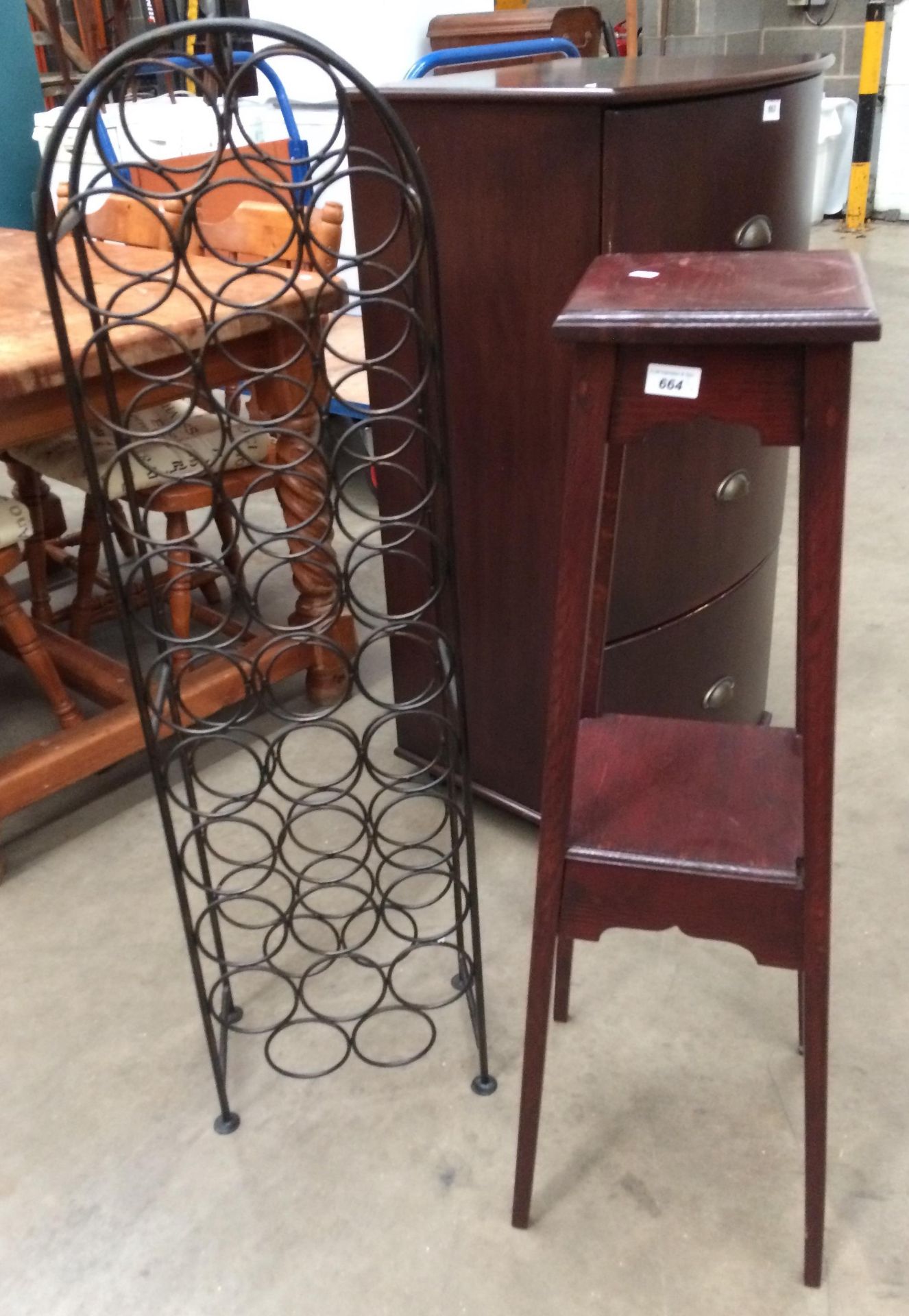 A metal freestanding 31 bottle wine rack and an oak finish plant stand