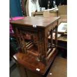 An oak nest of three coffee tables