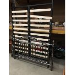 A 4'6" bed frame with silver finish head and base boards