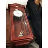 A Churchill Westminster Chime wall clock in mahogany finish case