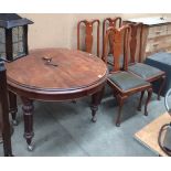 A mahogany oval extending dining table (one leaf) on turned legs, 106cm x 146cm when extended,