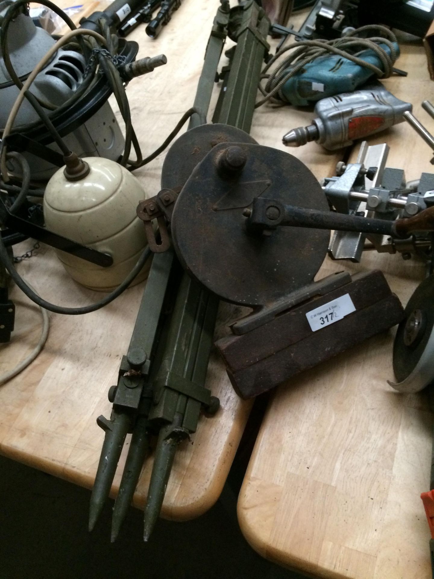 A hand crank grinding wheel and a vintage wood tripod (2)