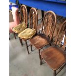 A set of four hoop back oak dining chairs