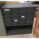 A black metal twenty drawer stores cabinet with under storage area - 85 x 40 x 100cm