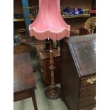 An oak standard lamp with pink shade