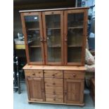 Pine wall unit with 3 upper glazed doors over 6 drawers,