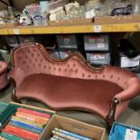 A mahogany framed Edwardian style chaise longue upholstered in deep buttoned pink dralon