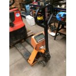 An orange and black metal pallet truck fitted with a U/UT - scales model TPS-11 with digital