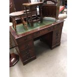 A mahogany finish nine drawer kneehole desk with tooled green leather finish incised top 122 x 60cm