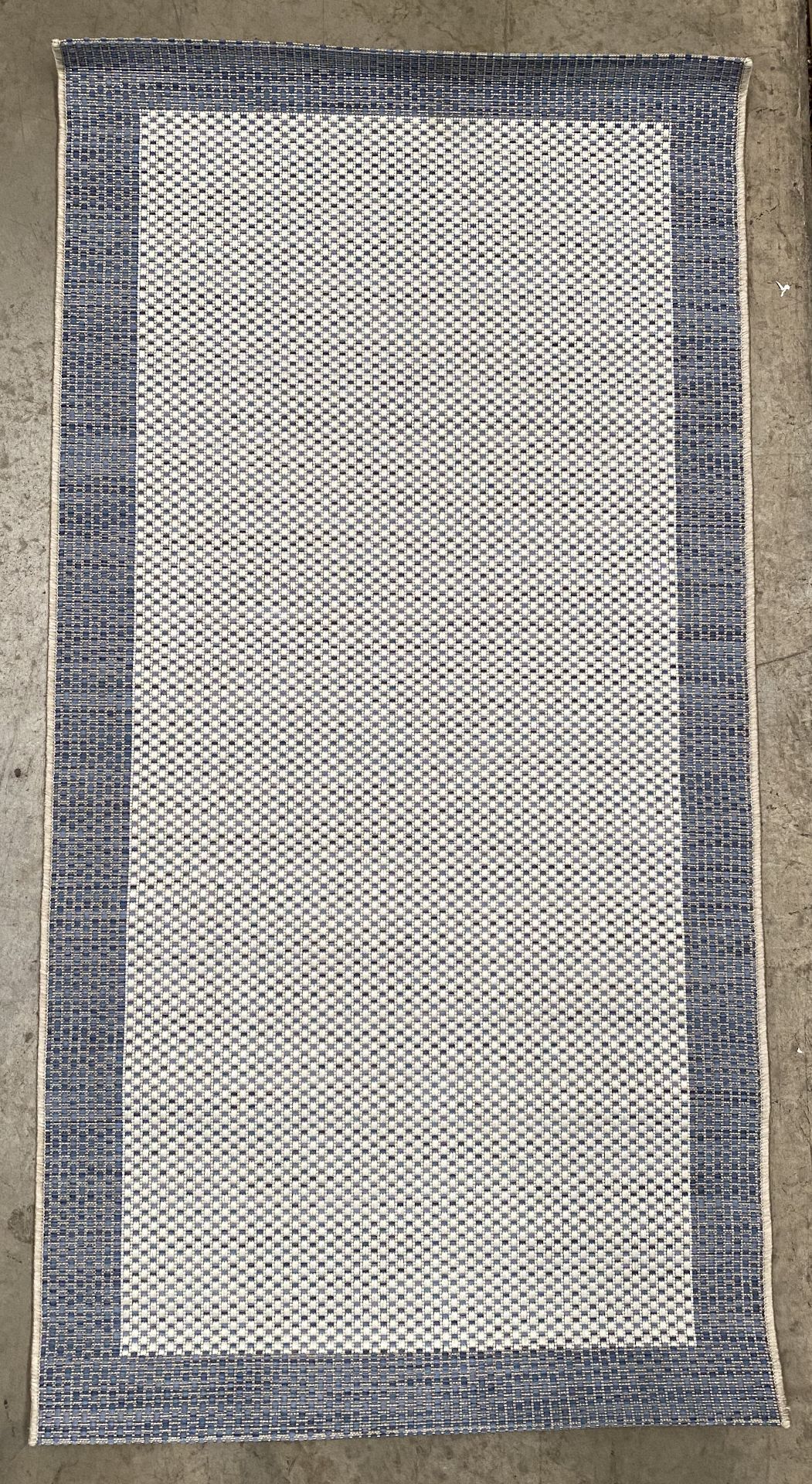 A premium flatweave blue and beige patterned rug - 150cm x 75cm