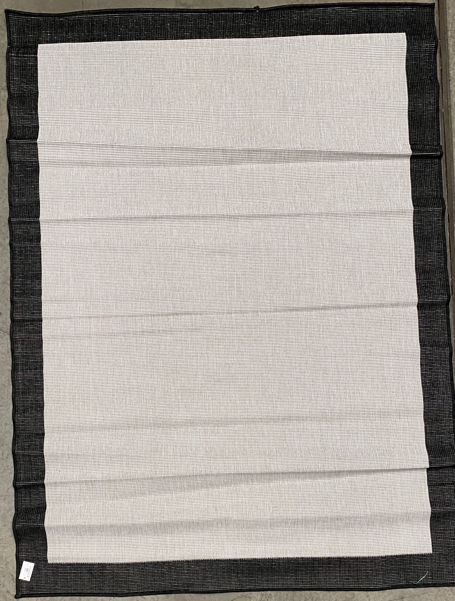 A black and beige rug - 220cm x 160cm
