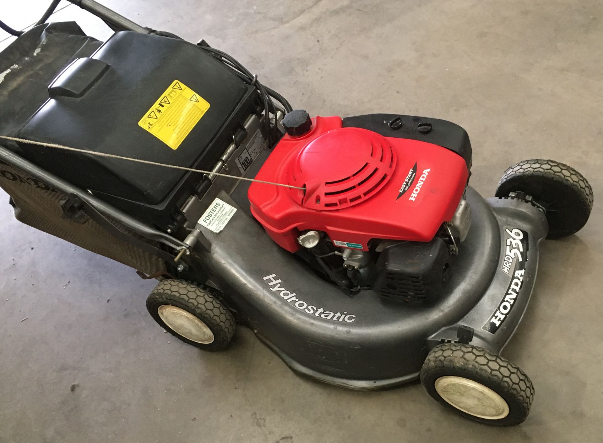 A Honda HRD 536 petrol rotary lawnmower with electric start, collection bag and manual.