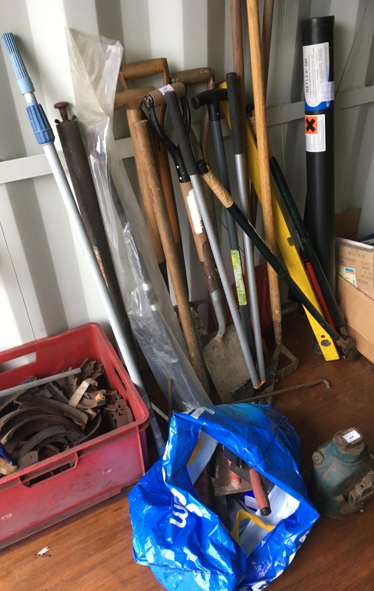 Contents to wall side and plastic bag - assorted garden tools - spades, forks,