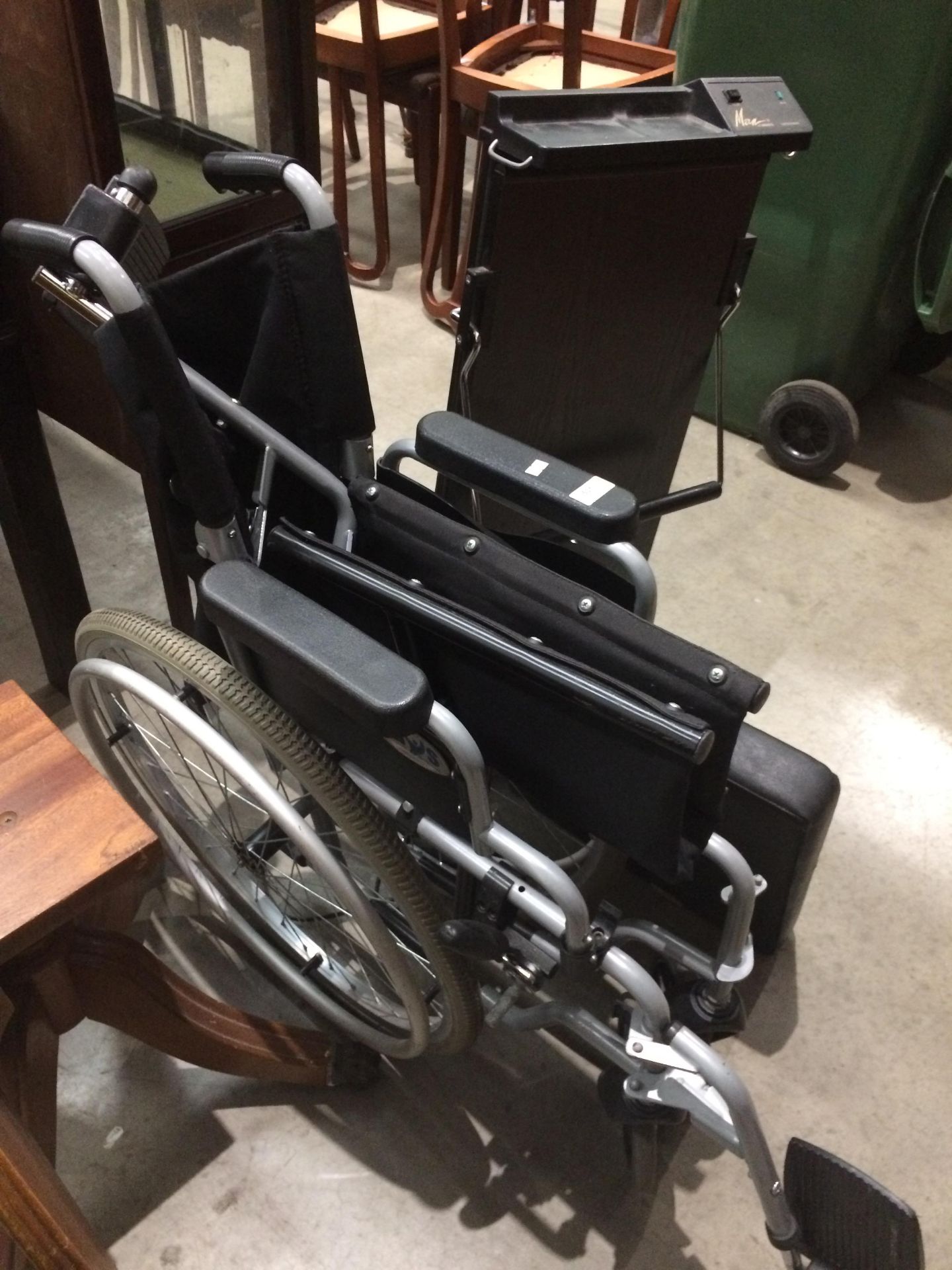 A folding wheelchair with foot rests and a Man by Carmen trouser press - 240v - plug cut off not