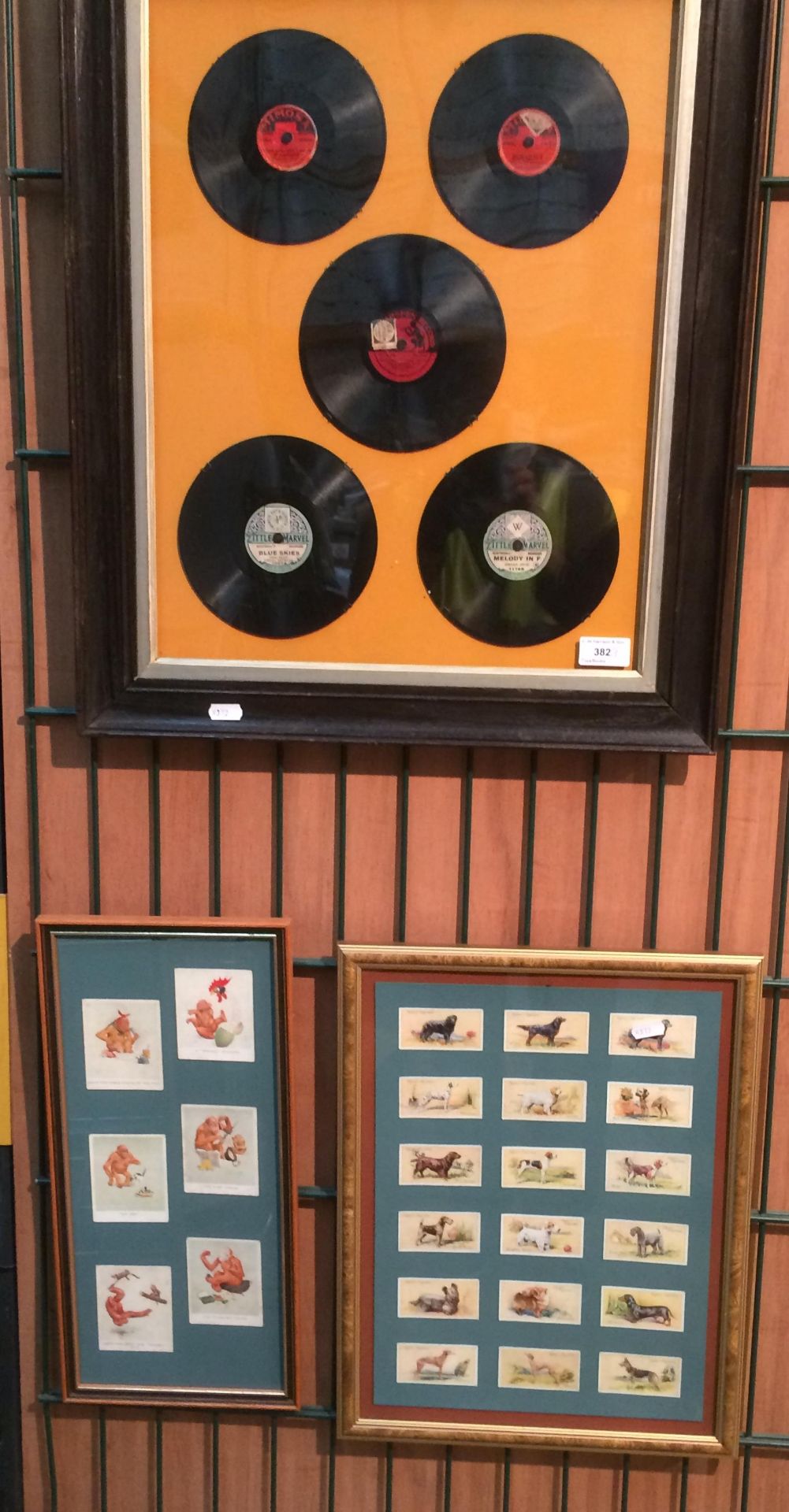 An oak framed record montage and two framed cigarette card/card montages Ogdens Dogs and humorous