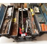 A blue metal toolbox and contents - assorted drill bits, spanners,
