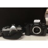 A Nikon F-801S camera and a Nikon FE3080132 camera