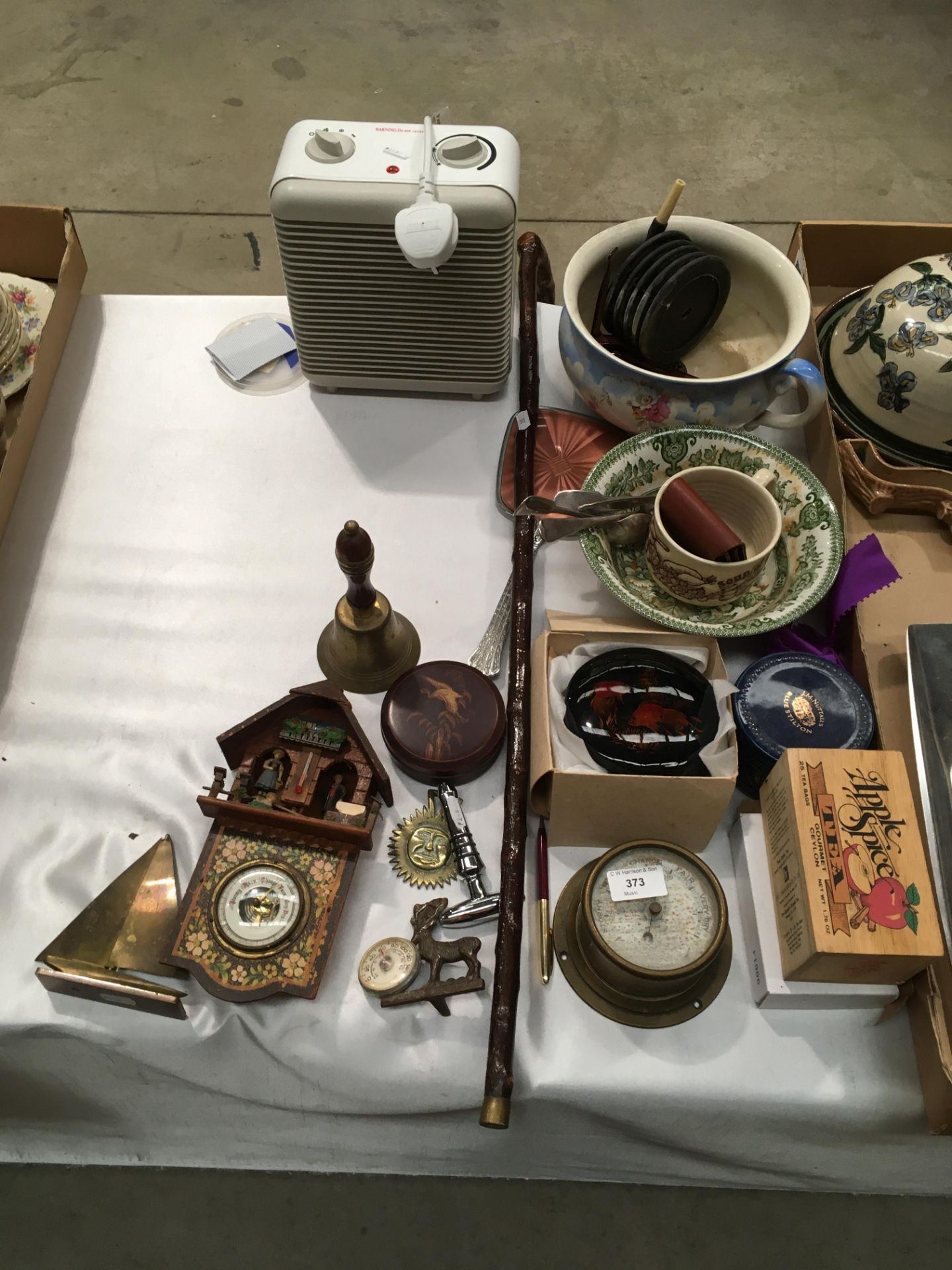 Contents to part table top - small fan heater, brass wall barometer, a floral patterned gazunder,