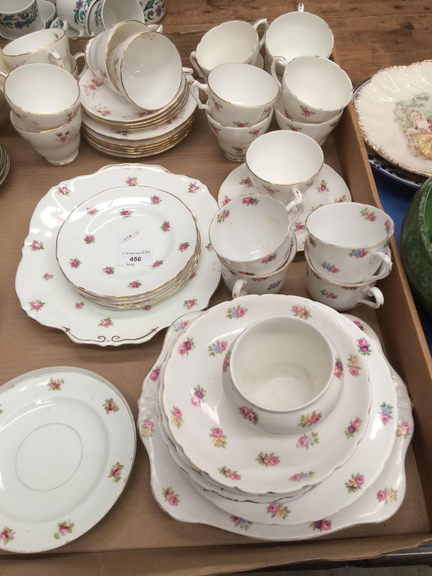 Approximately 48 pieces of red floral patterned tea services in three different styles