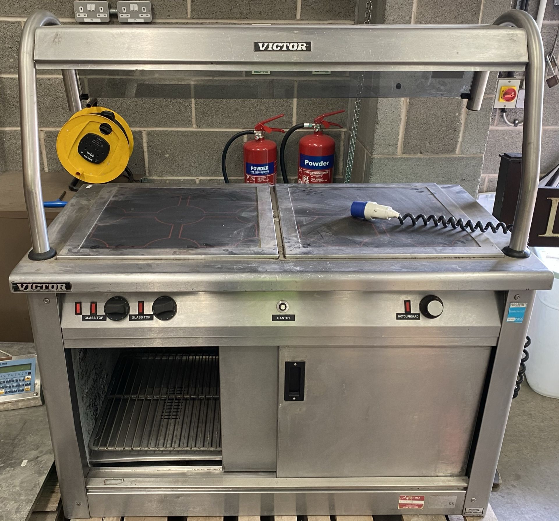 A Victor stainless steel cased food warming cabinet with double heated glass top and overhead