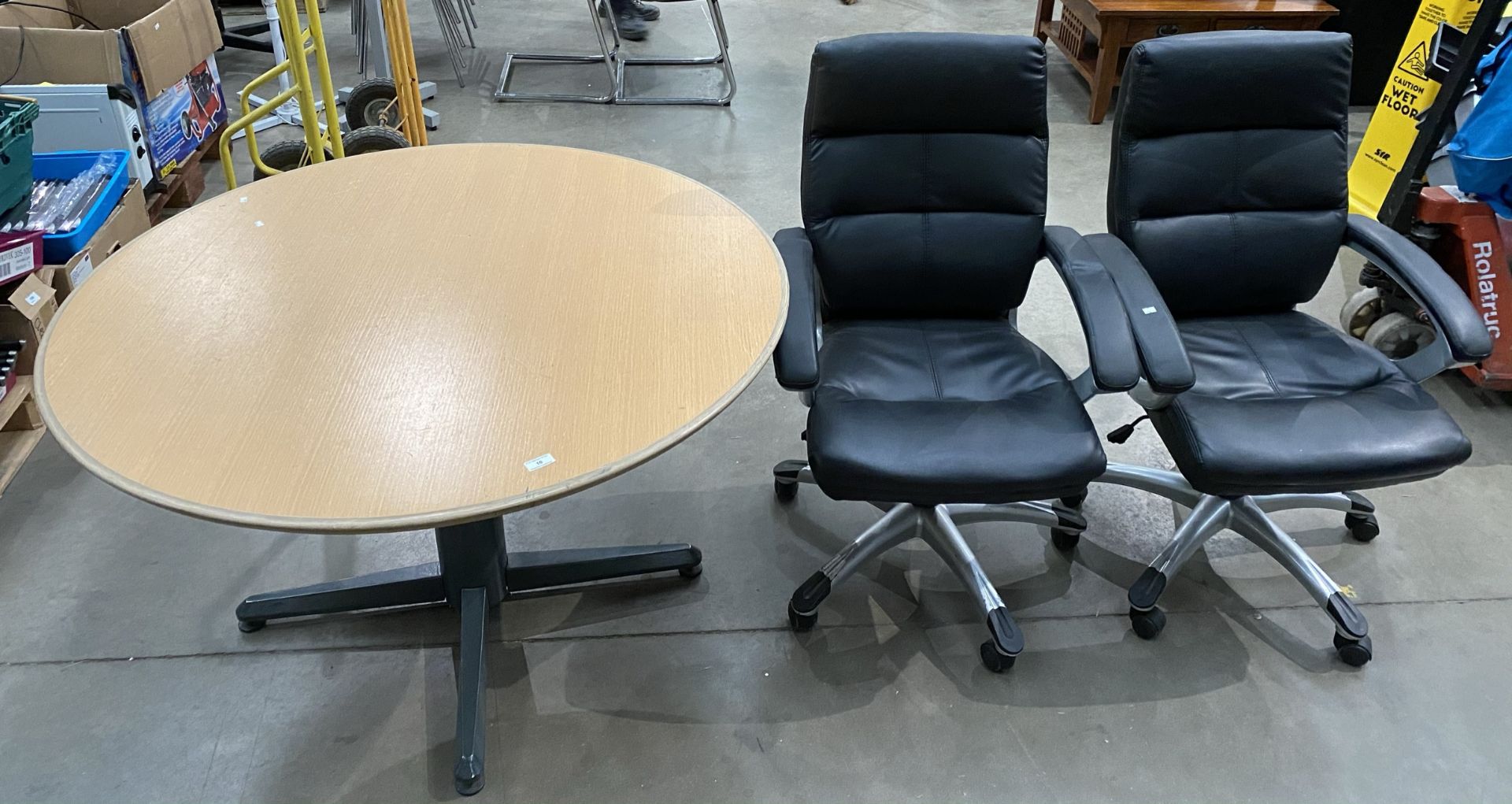 A Circular, light oak meeting table (120cm dia.