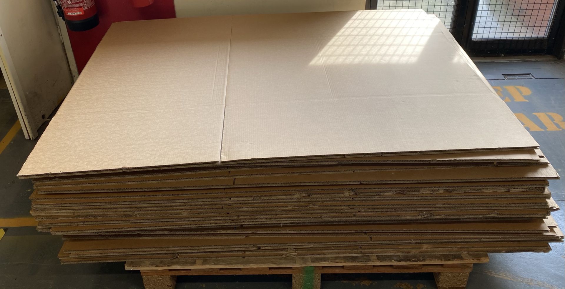 A part pallet of flat pack cardboard box