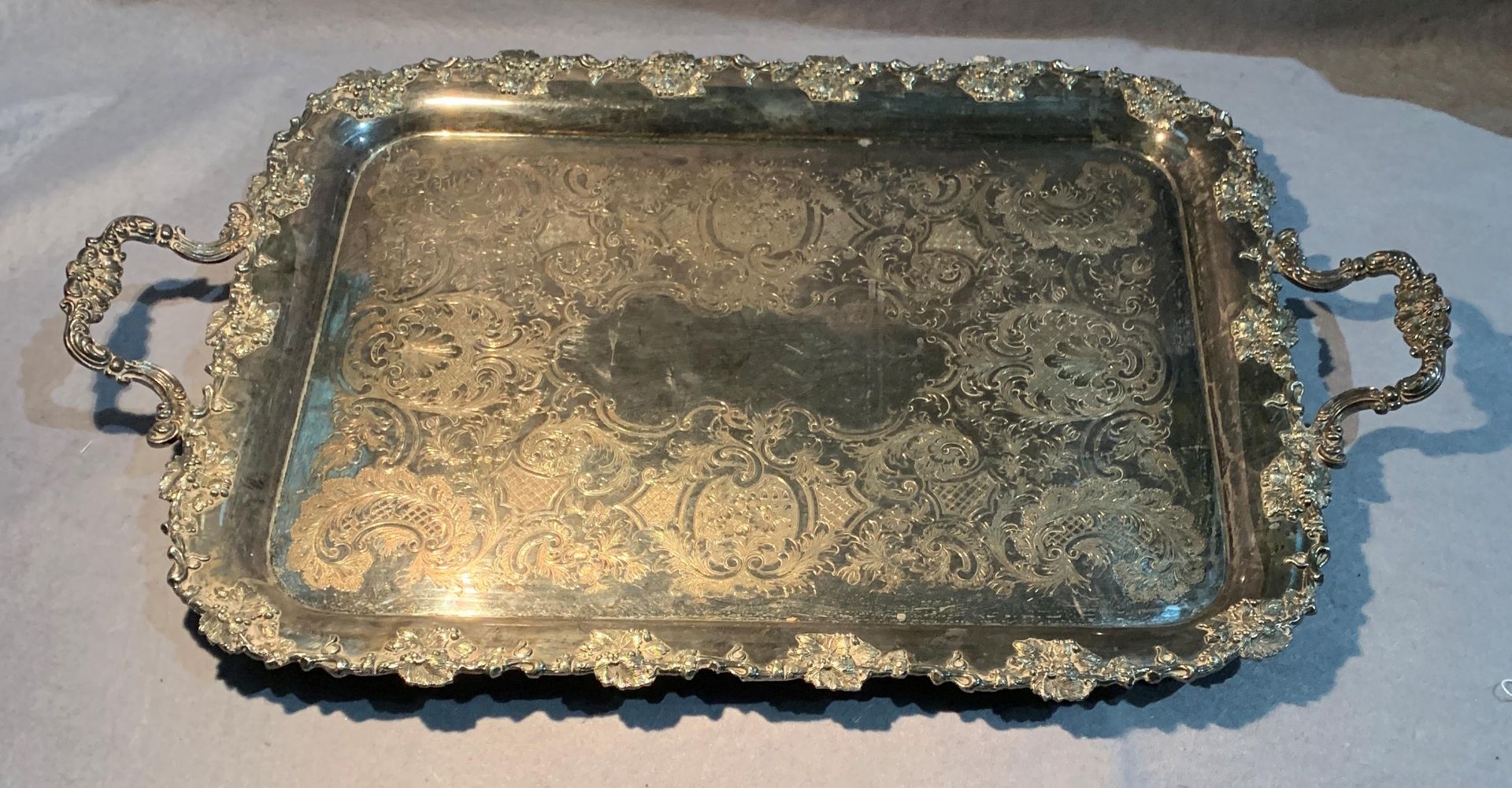 An engraved and decorated two handled silver plated tray,