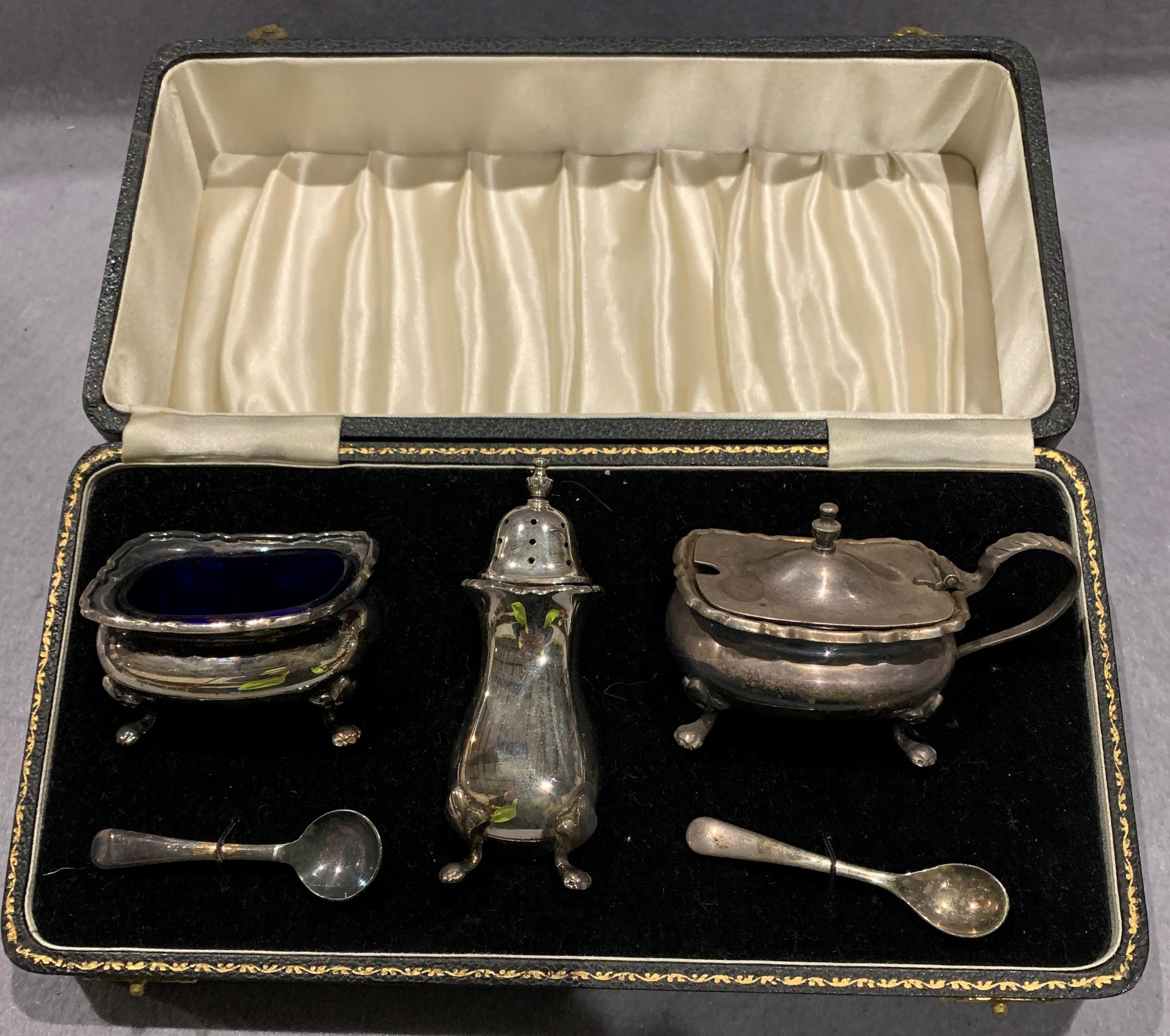 A silver plated condiment set in case