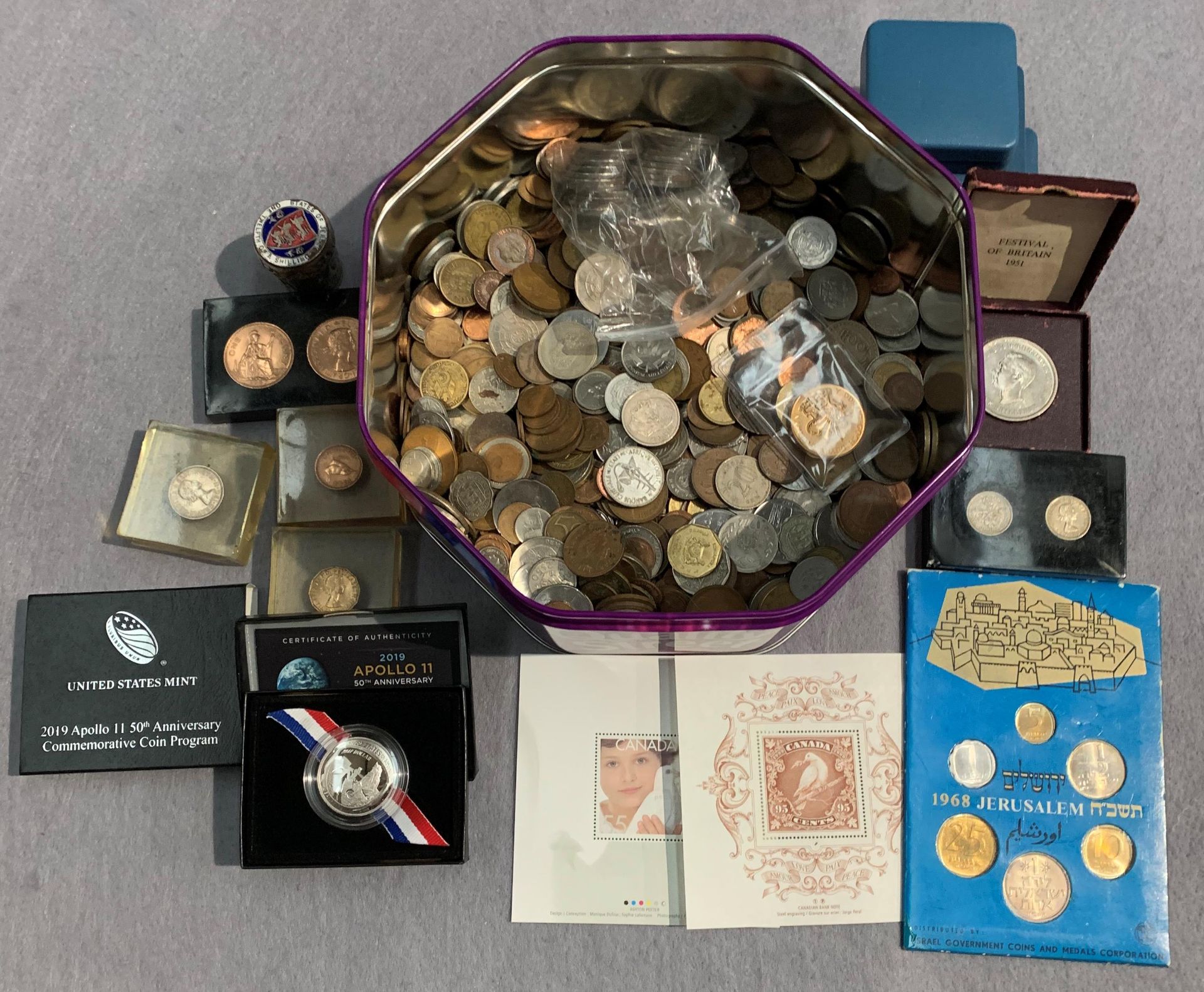 A large tin of world coins