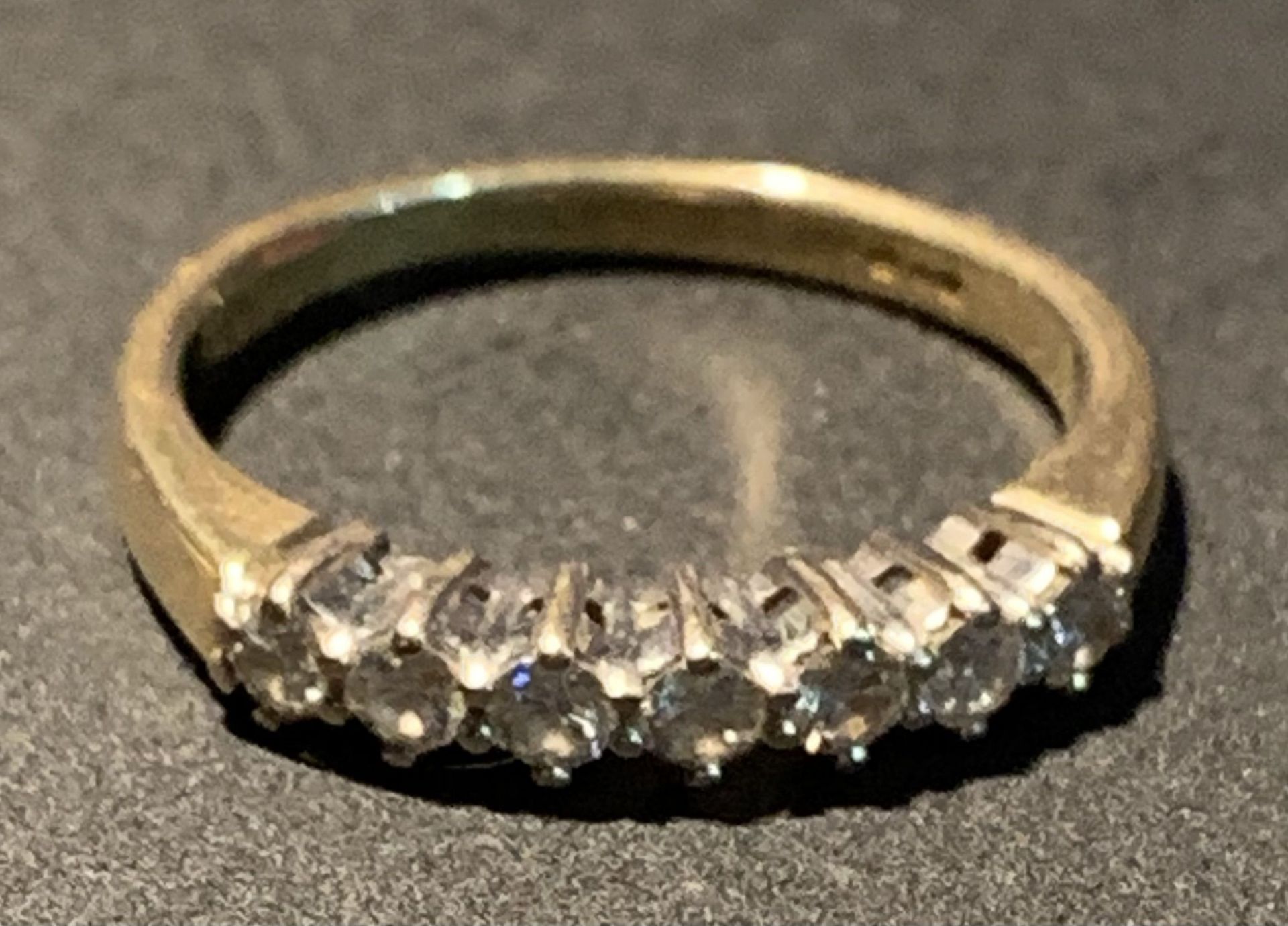 An 18ct gold half eternity ring, size K, set with seven diamonds,