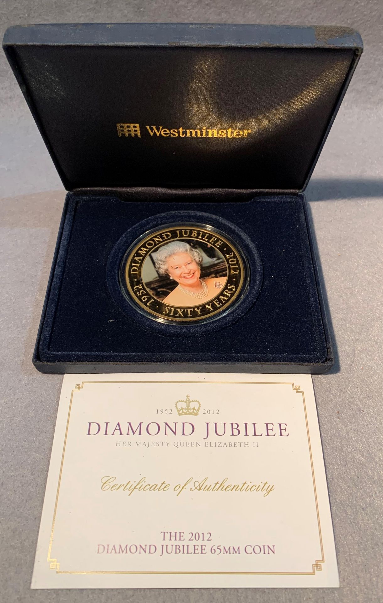 A Diamond Jubilee 5 dollar 65mm copper with 24 carat gold plating Cook Island coin in case