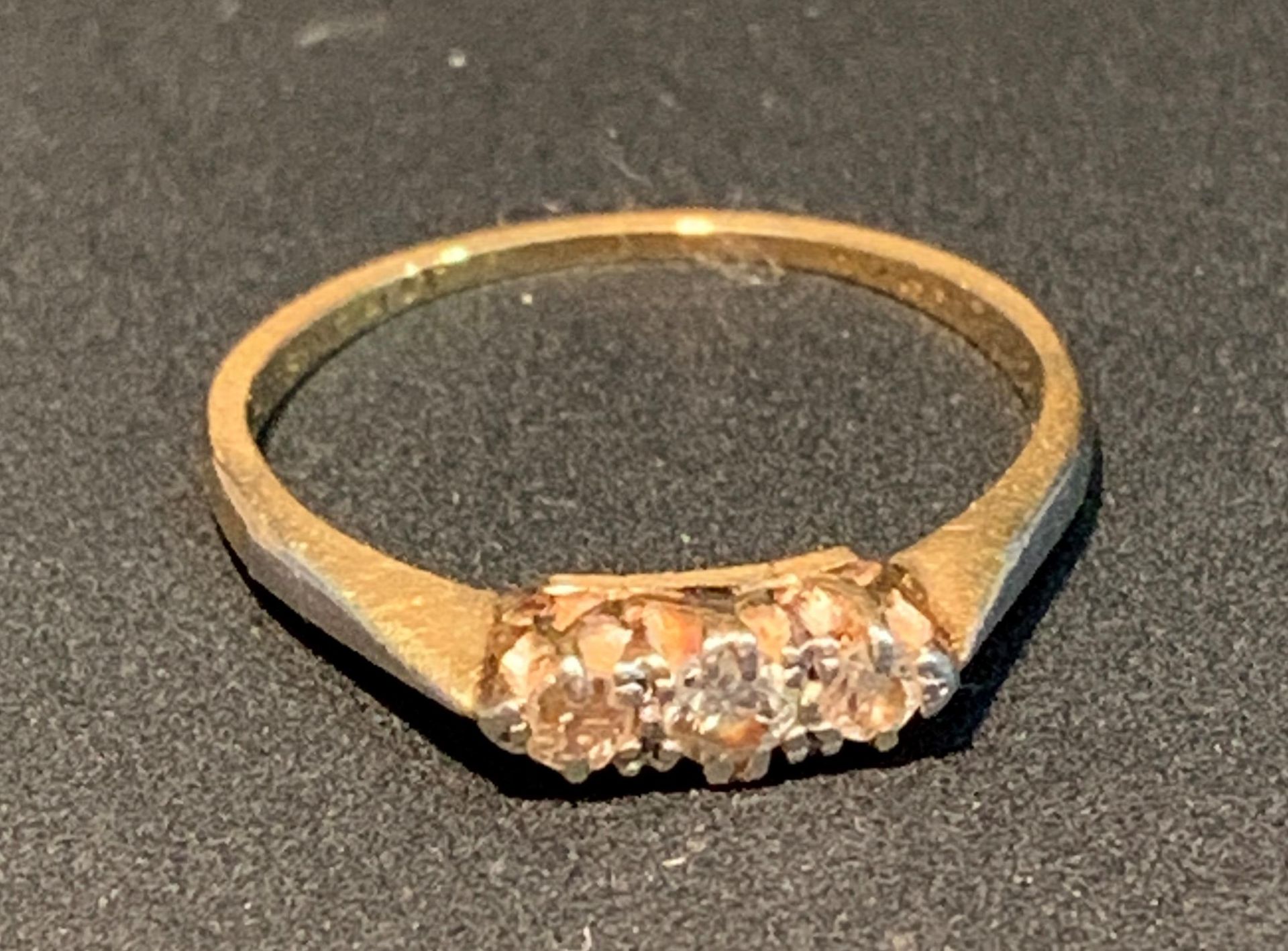 A gold three stone diamond ring, worn shank, size O, total weight 2.