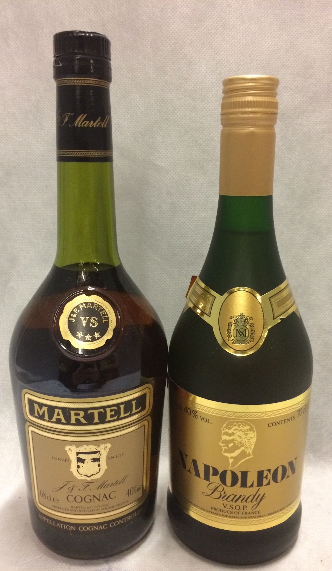 A 68cl bottle of Martell Cognac (40% volume) and a 70cl bottle of Napoleon V.S.O.