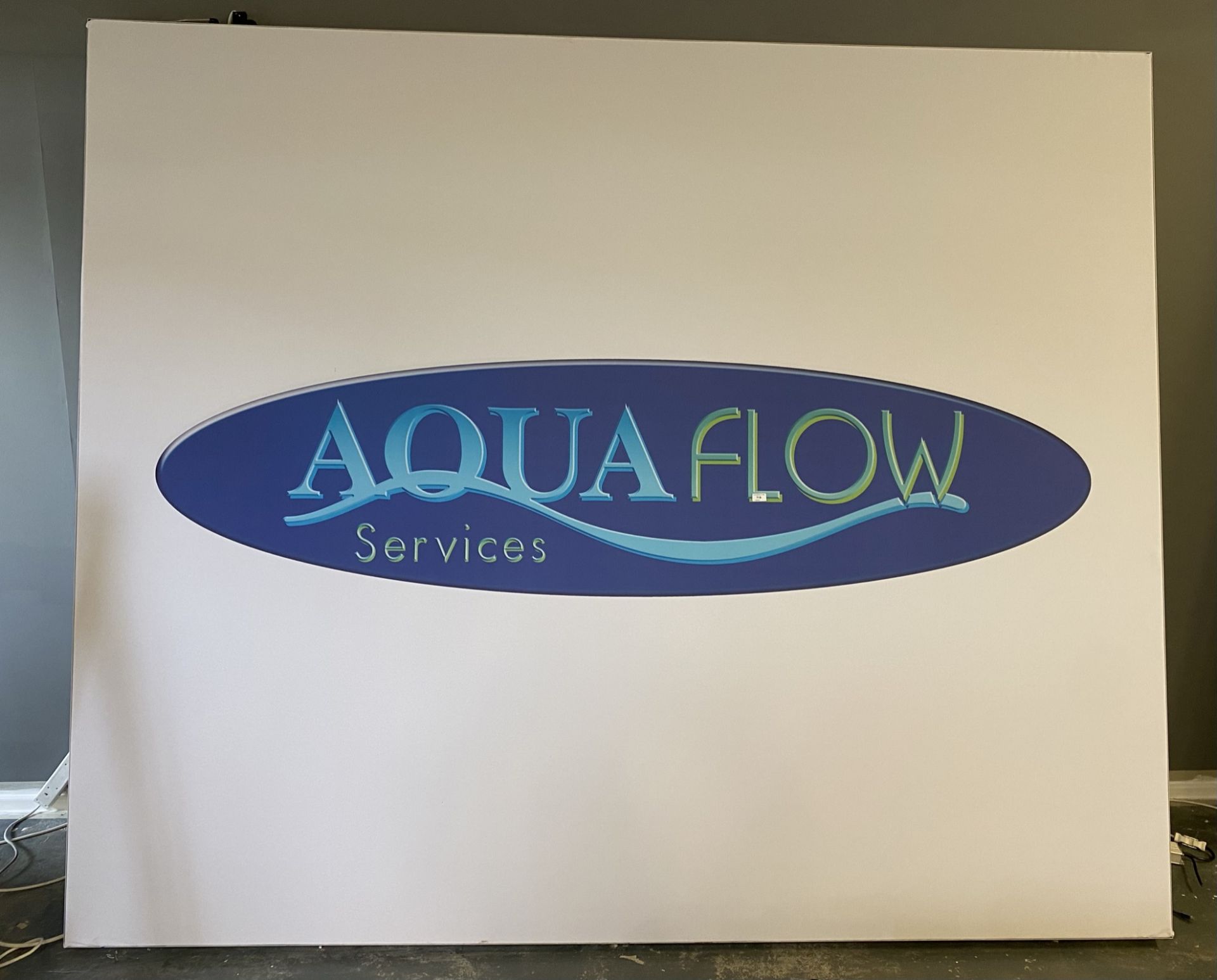 A large photographic rectangular illuminated light box with Aqua Flow Services logo - 245cm x 290cm