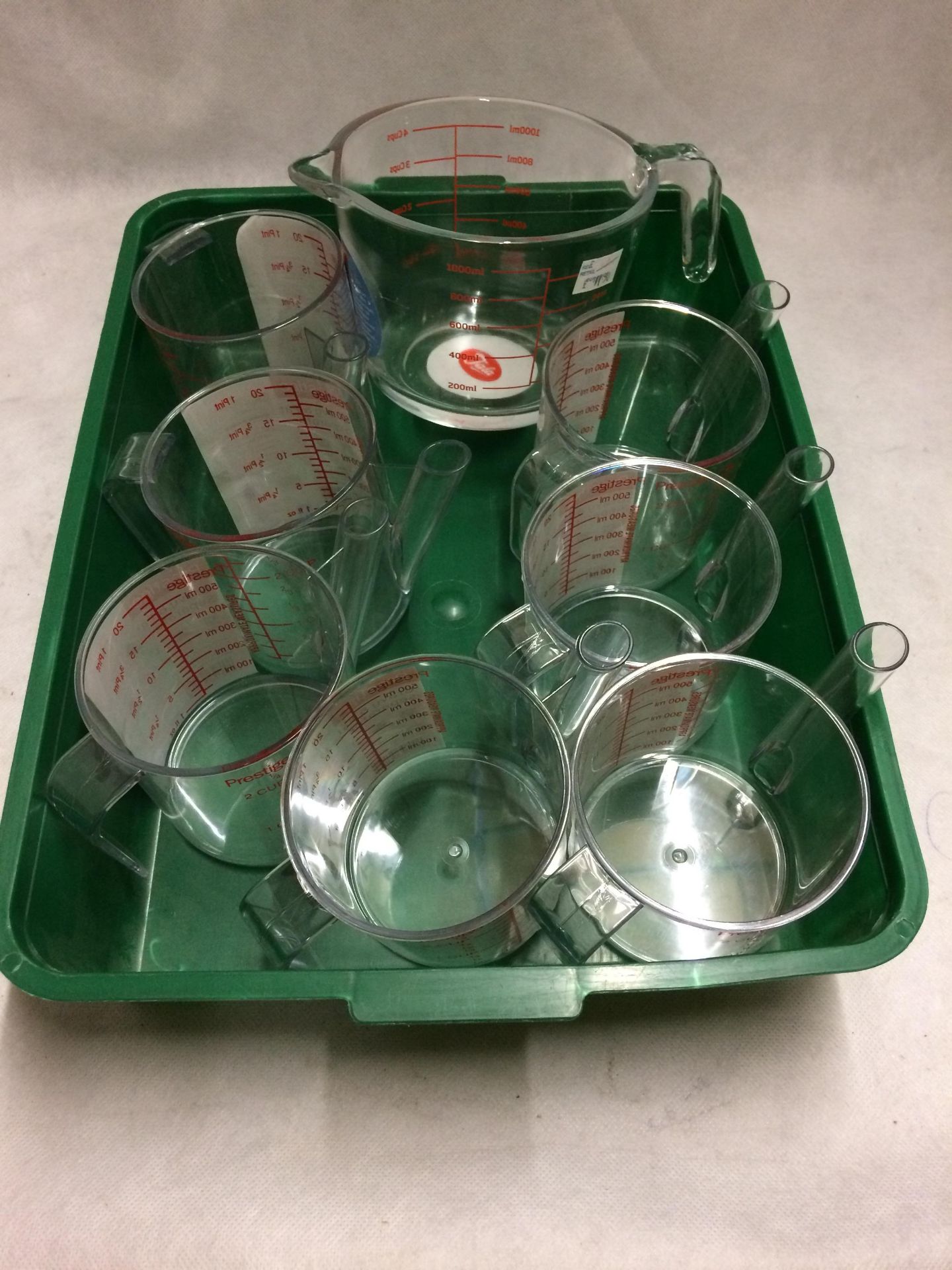 8 x plastic measuring jugs and 1 x glass