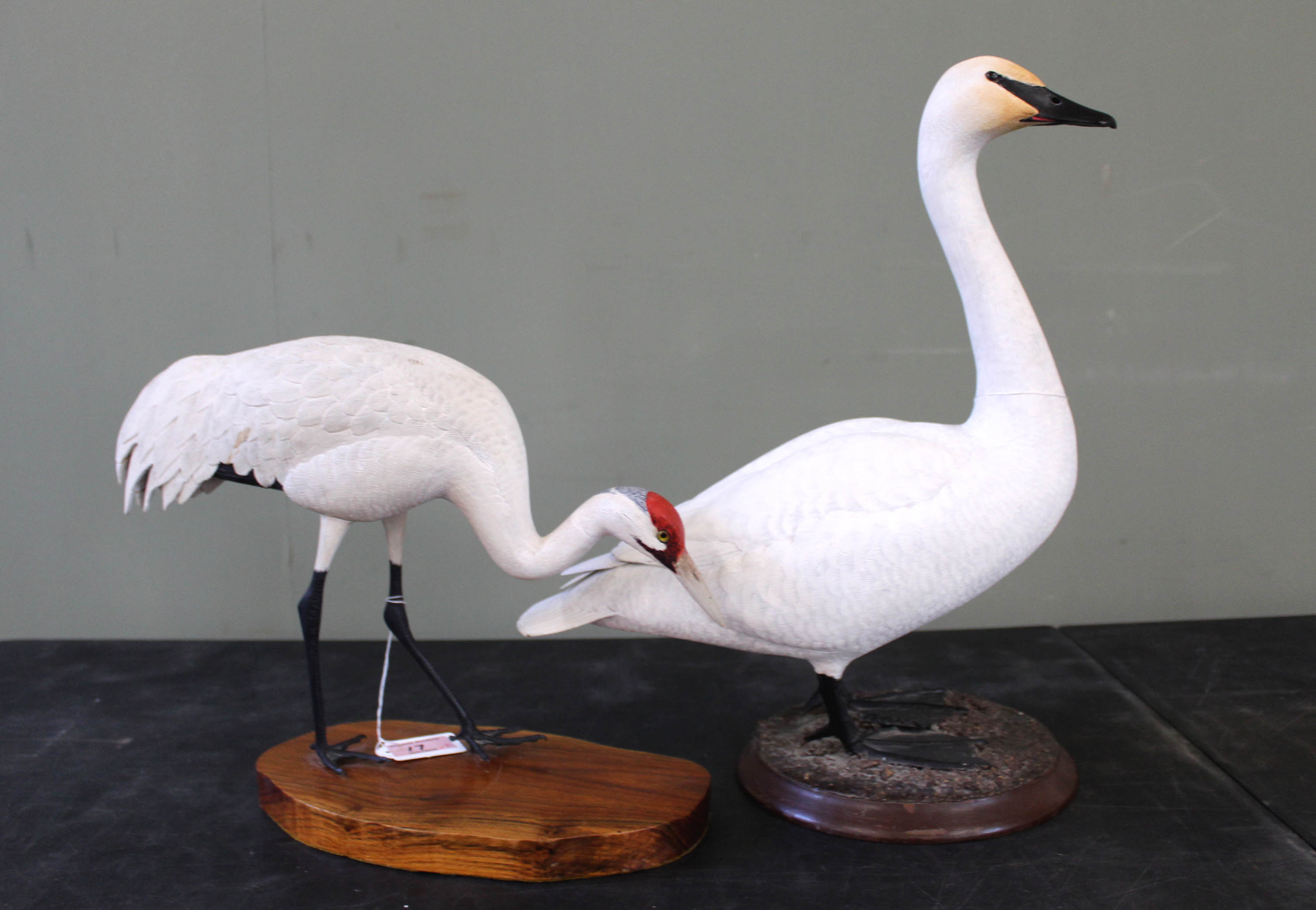 A hand carved and painted Swan and a Crane