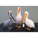 Three various Pelicans including a hand carved wooden example